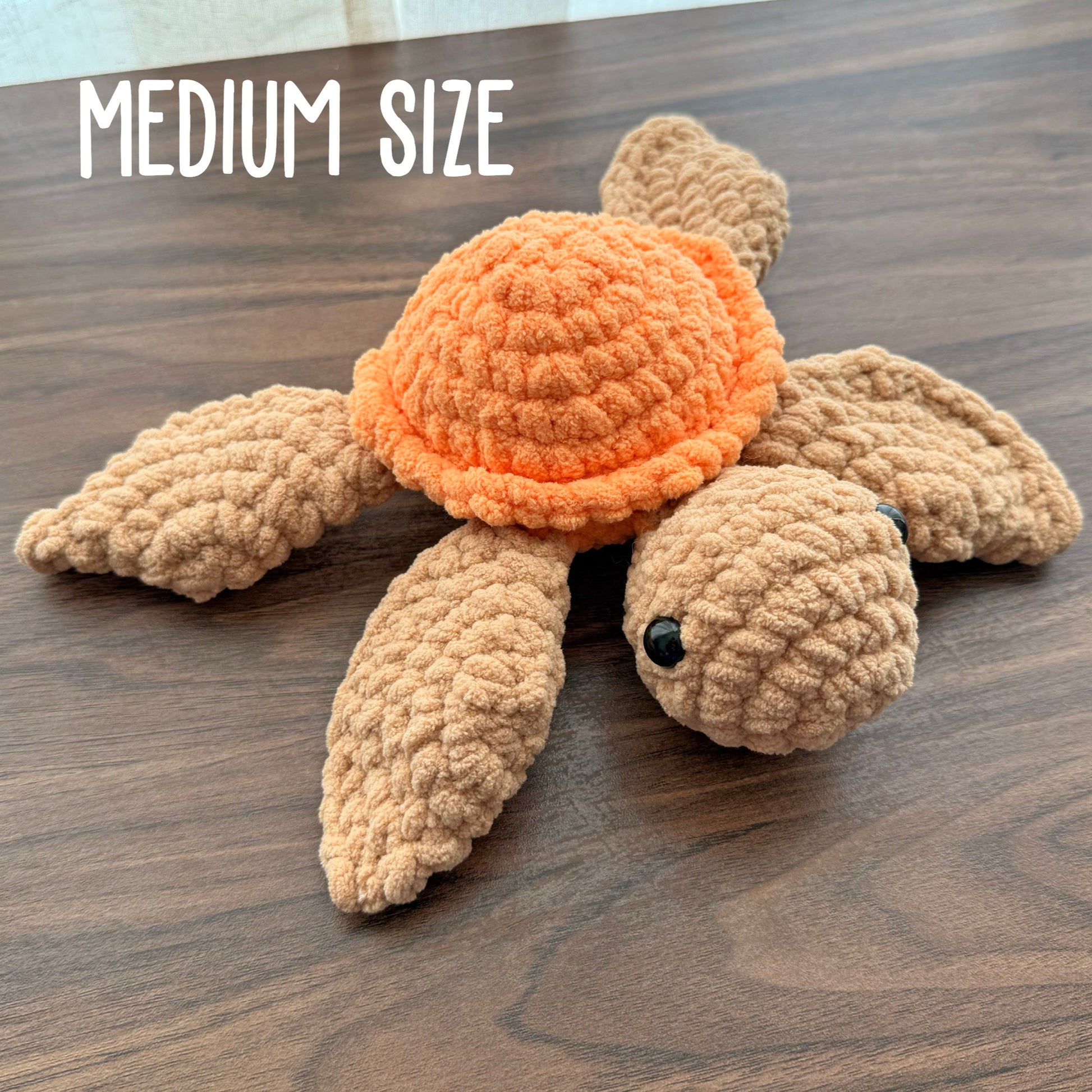 Medium turtle plush with an orange shell and tan body 